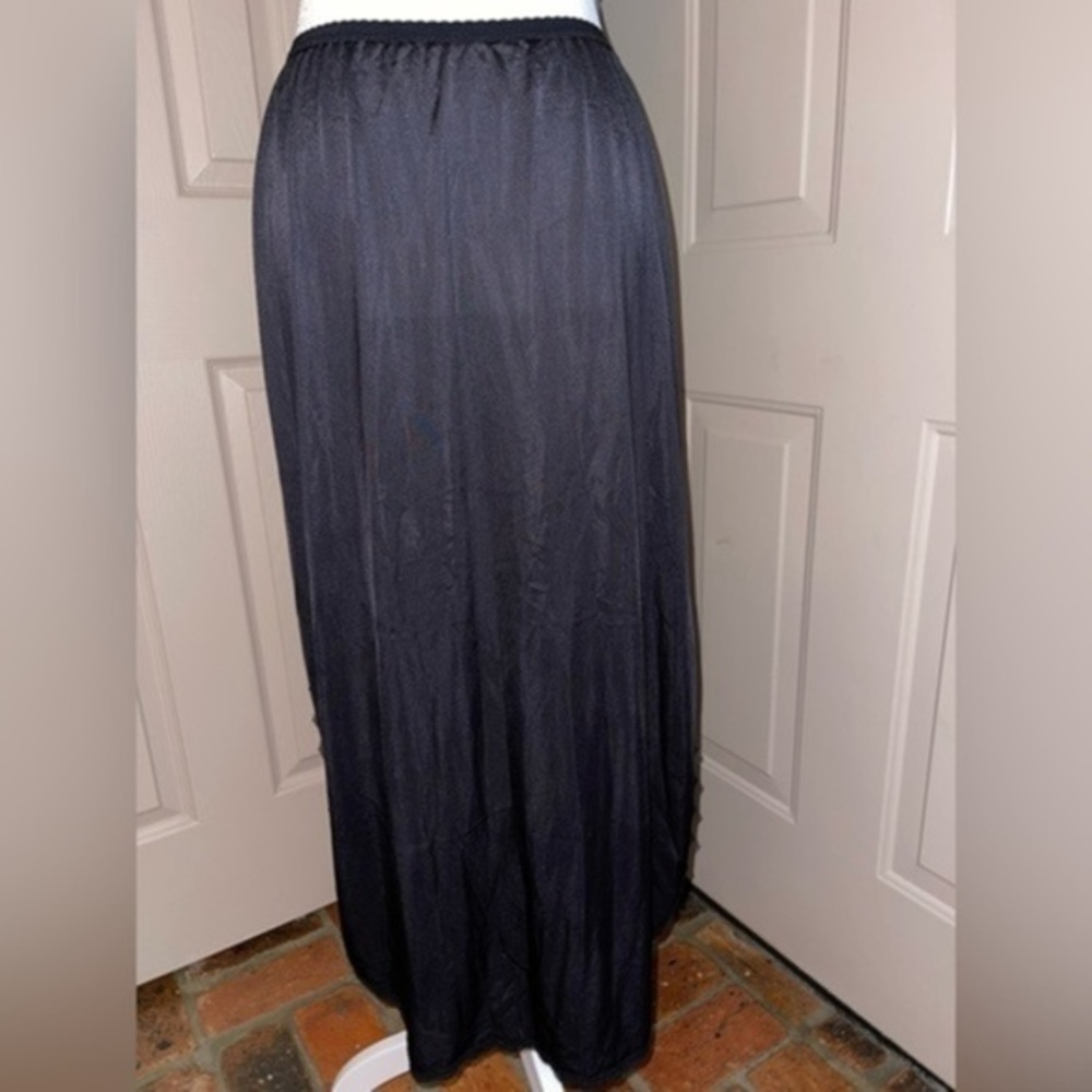 Vintage black nylon half slip with lace trim rounded hem & high side slits.
